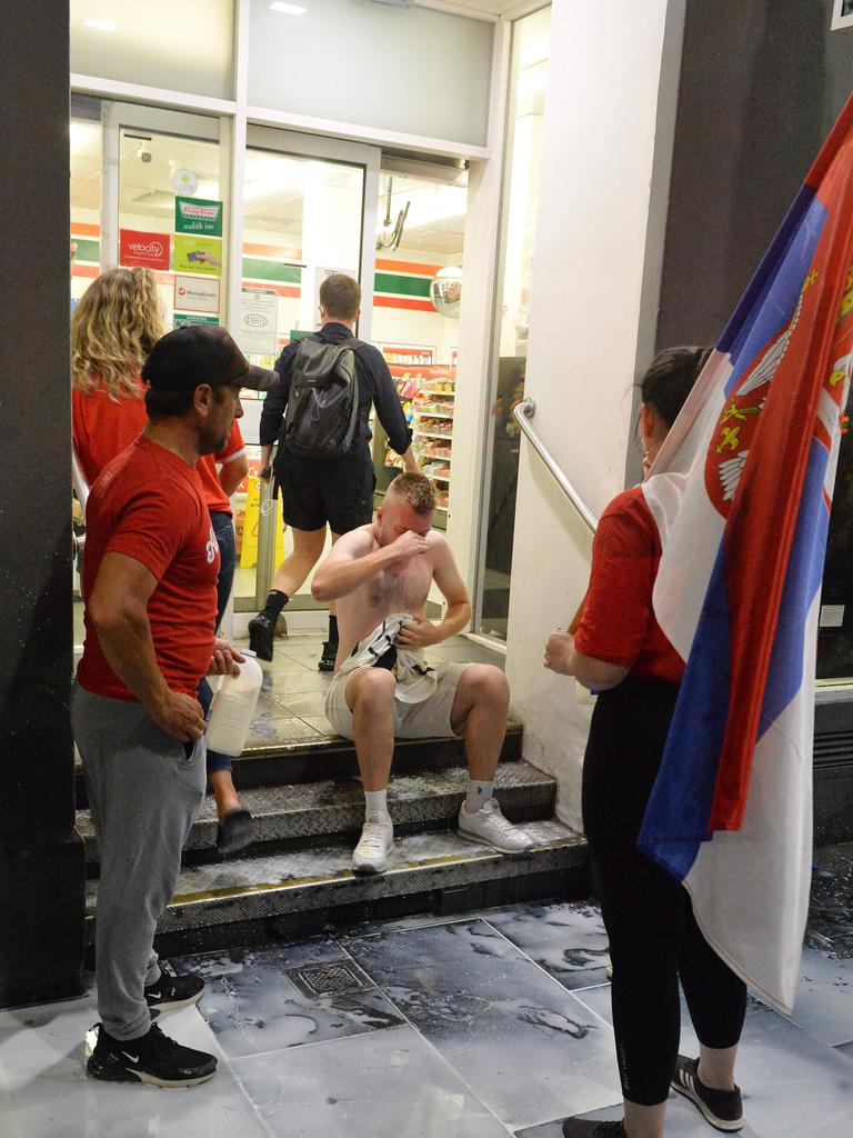 Supporters rush to a convenience store after being sprayed. Picture: Josie Hayden