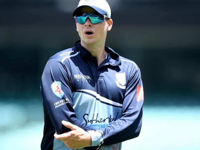 Steve Smith holds his elbow while playing for Sutherland. His injury means he might not be able to throw the ball in the field at the World Cup. Picture: AAP 