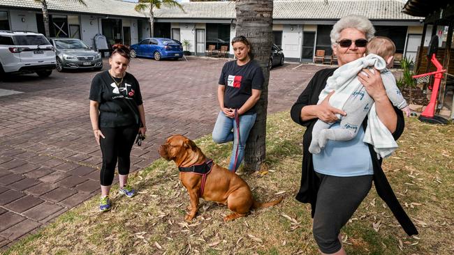 Angie, Cass Richardson with her dog Armani and Rose Brahimi with her grandson she is raising are staying in the emergency accommodation at Port Noarlunga Motel. Picture: Brenton Edwards