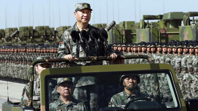 Chinese President Xi Jinping stands on a military jeep as he inspects troops of the People's Liberation Army during a military parade. Picture: AP