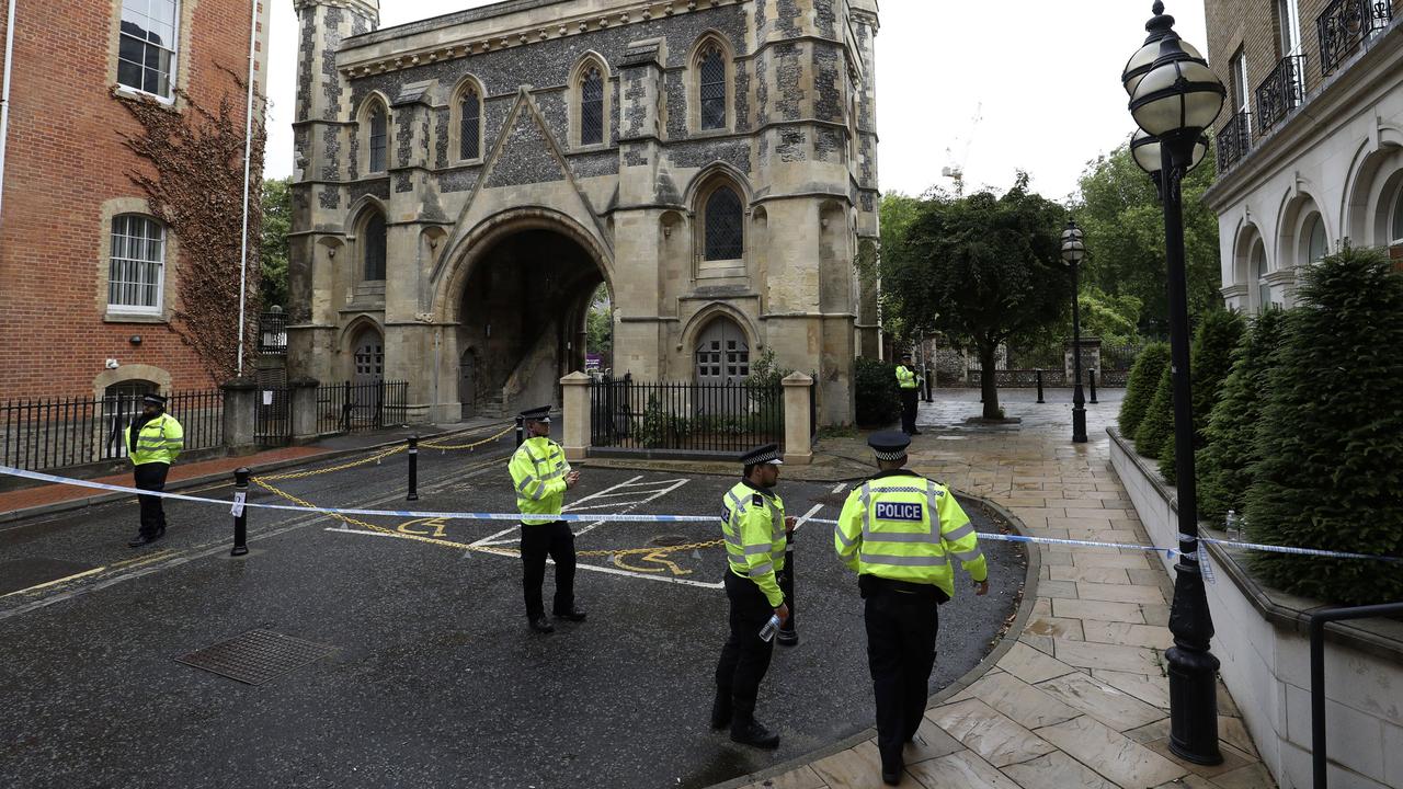 Police stand guard at the Abbey gateway of Forbury Gardens park in Reading town centre following Saturday&#039s stabbing attack in the gardens. Picture: Jonathan Brady/PA via AP