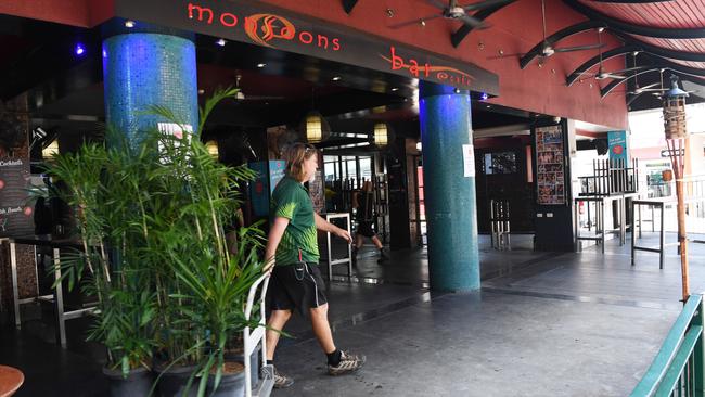 Monsoons’ staff members stack chairs and tables and remove indoor plants in the lead-up to the Monday 12pm deadline for pubs and other venues to close to prevent the spread of coronavirus. Picture: Katrina Bridgeford