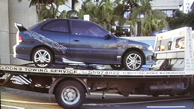 Police examine a car used in the killing on the M1 at Coomera. Picture: Channel 7