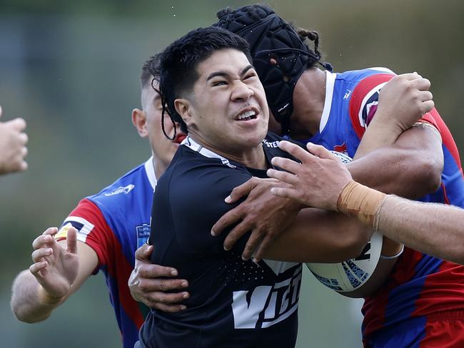 Jeremiah Leatigaga is tackled hard. Picture: Michael Gorton