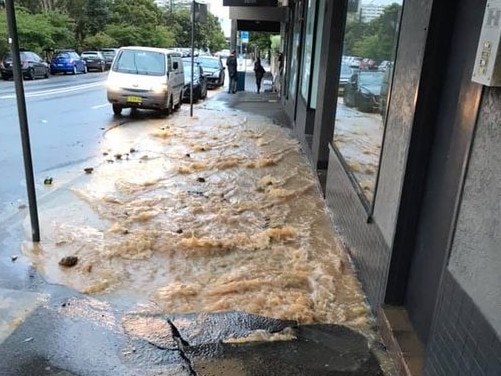 Water and debris cascading down Sydney Rd at Manly on Thursday night after a 150mm pipe broke. Picture: Facebook