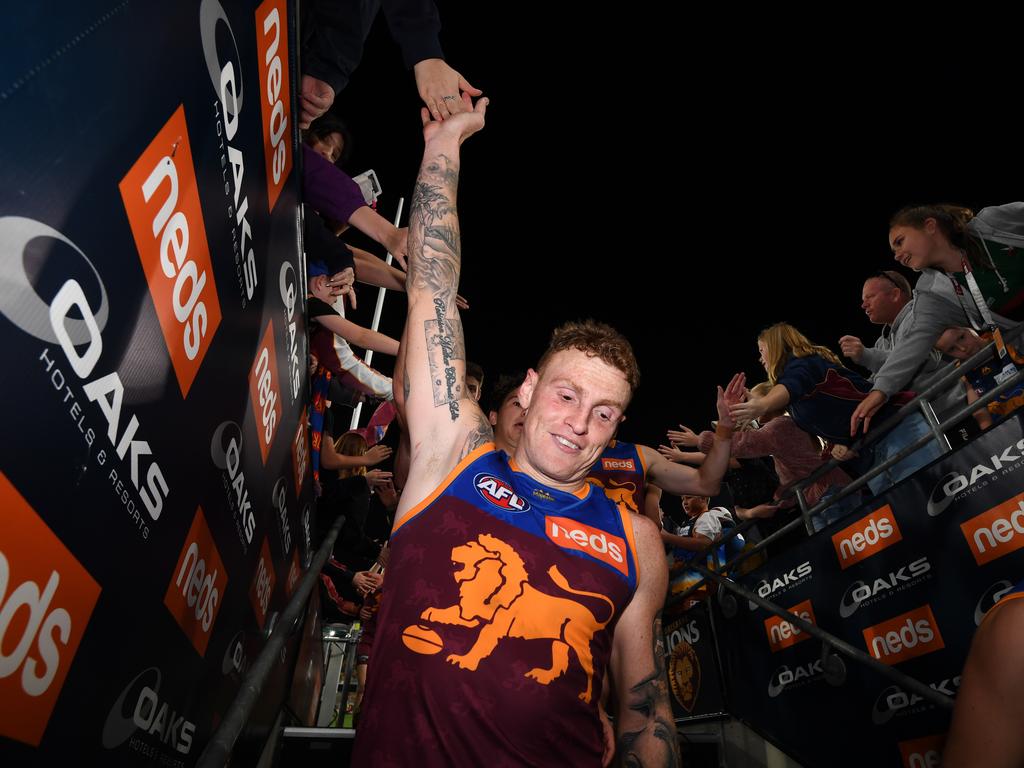 Mitch Robinson of the Lions high-fives fans after winning the Round 20 match between the Brisbane Lions and the Western Bulldogs - his SuperCoach owners would give him a big high five