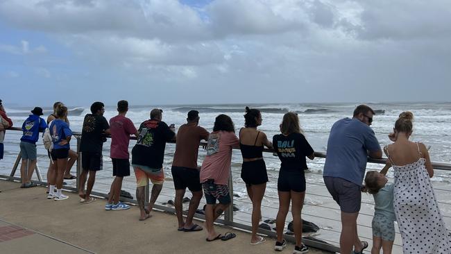 Gold Coasters braving the foreshore at Burleigh to look at the big swell. Picture: Chantay Logan