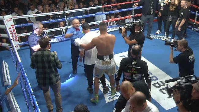 Referee John Cauchi in the thick of things in the Paul Gallen-Justin Huni fight in Sydney on Wednesday night.