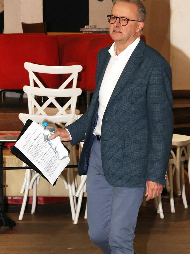 Anthony Albanese carrying a folder and notes to his press conference. Picture: Liam Kidston