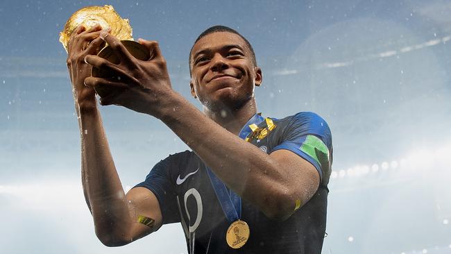 Kylian Mbappe of France celebrates with the World Cup trophy.