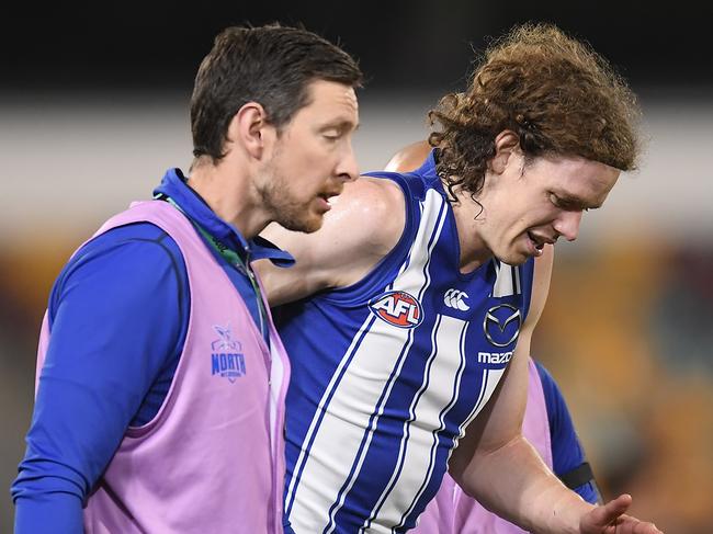BRISBANE, AUSTRALIA - AUGUST 05: Ben Brown of the Kangaroos walks off the field injured during the round 10 AFL match between the Geelong Cats and the North Melbourne Kangaroos at The Gabba on August 05, 2020 in Brisbane, Australia. (Photo by Albert Perez/AFL Media/via Getty Images)