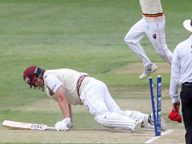 ADELAIDE, AUSTRALIA - NOVEMBER 22:  Joe Burns of the Queensland Bulls run out for 85 runs by  Jake Carder of the Redbacks who is celebrating in the background during the Sheffield Shield match between South Australian Redbacks and Queensland Bulls  at Adelaide Oval, on November 22, 2022, in Adelaide, Australia. (Photo by Sarah Reed/Getty Images)