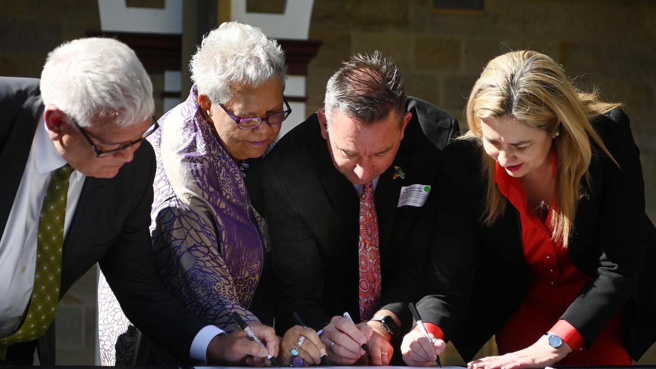 Premier Annastacia Palaszczuk, Minister for Aboriginal and Torres Strait Islander Partnerships Craig Crawford, Treaty Advancement Committee Co-Chair Dr Jackie Huggins and fellow Co-Chair Mick Gooda signing the Statement of Commitment at Parliament House in Brisbane. Picture: NCA NewsWire / Dan Peled