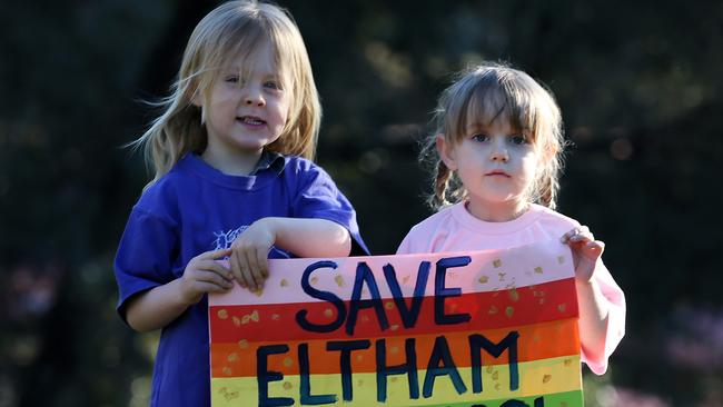 Idris and Pippa hold a sign made by kinder kids. Picture: George Salpigtidis