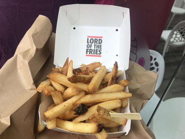 These fries come in a cardboard box with a lid plus a little wooden fork.