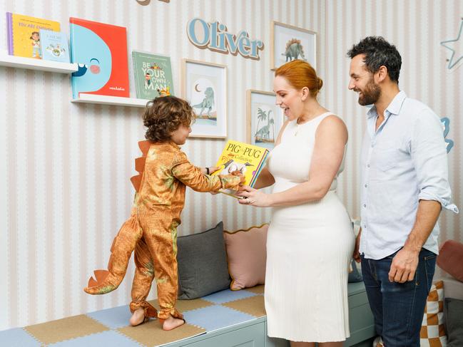 Jules Robinson, son Oliver, 3, and husband Cam Merchant at their home in Sydney. Ollie loves books and reading - and his mum’s first book Ask Jules is out now. Picture: Max Mason-Hubers