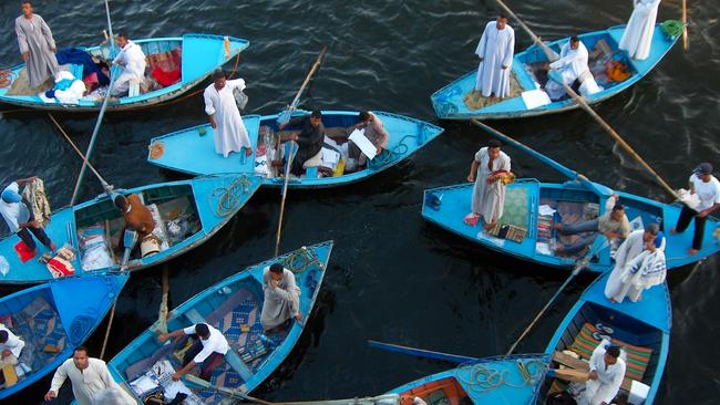 Merchants are seen selling goods to passengers on a Nile Cruise ship in Esna, Egypt in 2006.