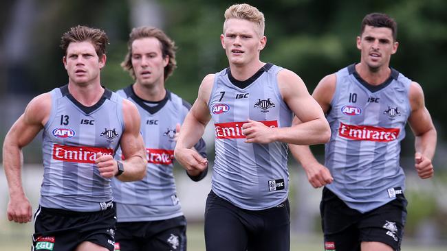 Adam Treloar, second from right, at Collingwood training.