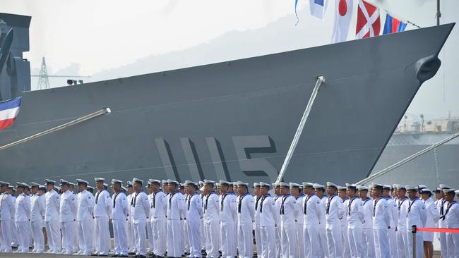 Taiwan sailors parade in front of the 'Feng Chia' navy frigate during a ceremony to commission two guided missile frigates from the US into the Taiwan Navy. Picture: AFP