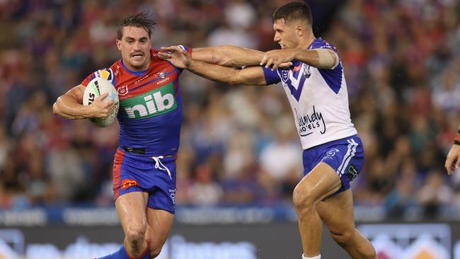 NEWCASTLE, AUSTRALIA - MARCH 12: Connor Watson of the Knights is tackled by Jake Averillo of the Bulldogs during the round one NRL match between the Newcastle Knights and the Canterbury Bulldogs at McDonald Jones Stadium, on March 12, 2021, in Newcastle, Australia. (Photo by Ashley Feder/Getty Images)