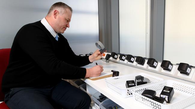 Our most dangerous offenders are required to wear electronic devices after release from prison. Equipment team leader Aaron puts together the anklet. Picture: Toby Zerna