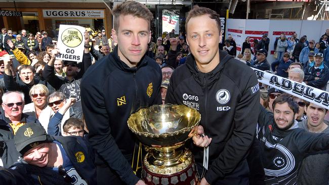 Glenelg’s Chris Curran with Port Adelaide captain Cameron Sutcliffe.