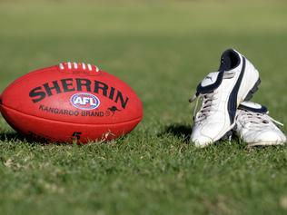 Generic AFL Sherrin football and football boots. sport /