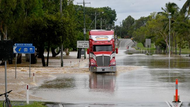 Flooding at Plantation Creek in Ayr cuts the Bruce Highway to traffic apart from trucks. Picture: Evan Morgan