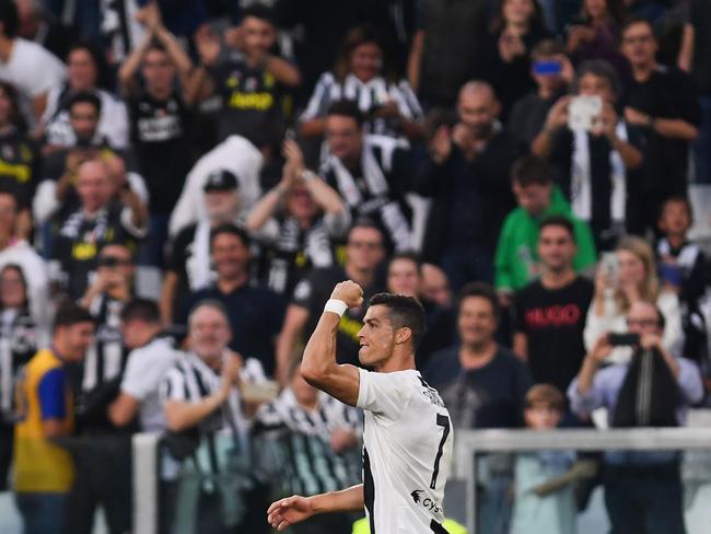 TOPSHOT - Juventus' Portuguese forward Cristiano Ronaldo celebrates after opening the scoring during the Italian Serie A football match Juventus vs Genoa on October 20, 2018 at the Juventus Allianz stadium in Turin. (Photo by Marco BERTORELLO / AFP)