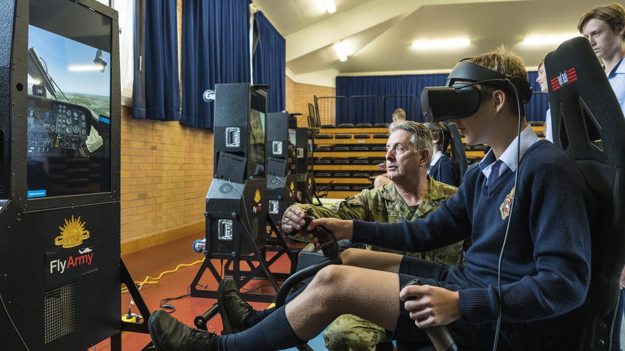 Aviation STEM Motivation Program OIC Major David McEvoy instructs Toowoomba Anglican School student Lachlan Weier in the use of a VR helicopter flight simulator. Picture: Kevin Farmer