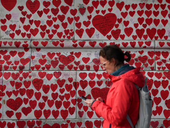 A pedestrian walks past the National Covid Memorial Wall, dedicated to those who lost their lives to Covid-19, in London. Picture: AFP