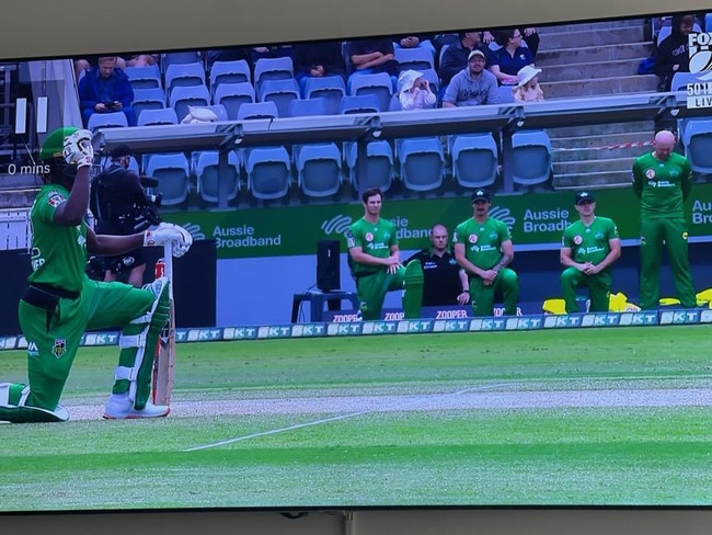 Ben Dunk stands again as his teammates kneel.