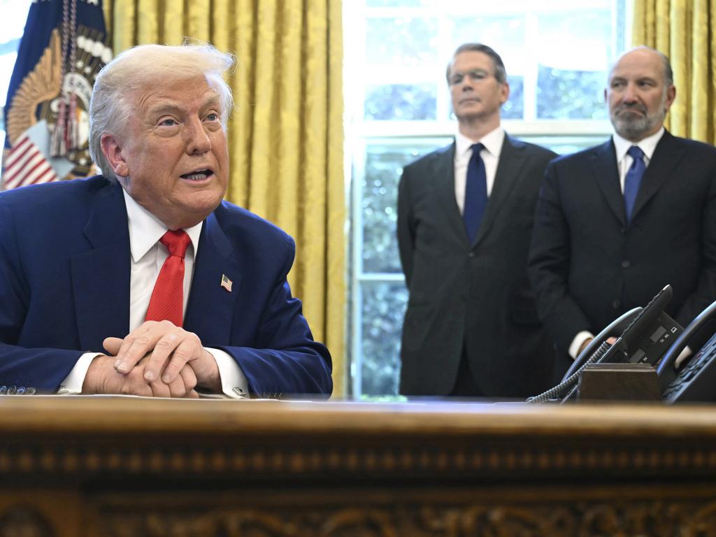 Mr Trump with Treasury Secretary Scott Bessent and Commerce Secretary Howard Lutnick. Picture: Pool via AP