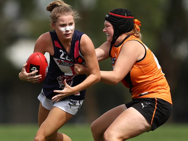 MELBOURNE, AUSTRALIA - MARCH 20: Emma Stuber of the Sandringham Dragons (L) is tackled during the NAB League Girls Match between the Calder Cannons and Sandringham Dragons at Highgate Reserve on March 20, 2022 in Melbourne, Australia. (Photo by Graham Denholm/AFL Photos/via Getty Images )