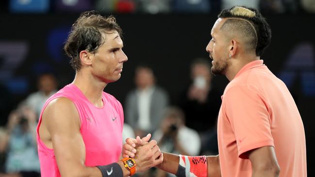 Nick Kyrgios shakes hands with Rafael Nadal.