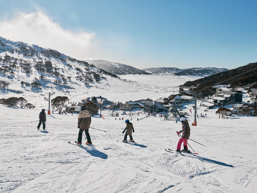 Family enjoying a day of skiing at Charlotte Pass Ski Resort in the Snowy Mountains. Picture: Destination NSW