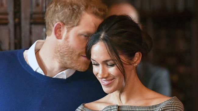 Britain's Prince Harry and Meghan Markle watch a performance Cardiff Castle in Cardiff, Wales, Thursday, Jan. 18, 2018. During their tour, Prince Harry and Ms. Markle will hear performances from musicians and poets, meet sportsmen and women, and see how organisations are working to promote Welsh language and cultural identity. (Ben Birchall/Pool Photo via AP)