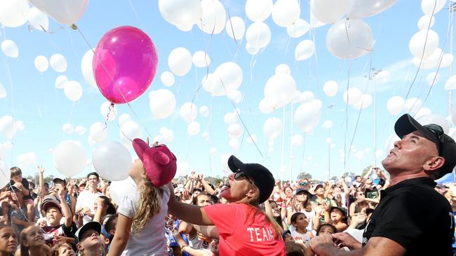 Aria, aged four, with Tara Brown’s mother Natalie Hinton and stepfather Jonny Gardner at the Tara Brown Foundation touch football fundraiser at Coomera. Photo: Regi Varghese.