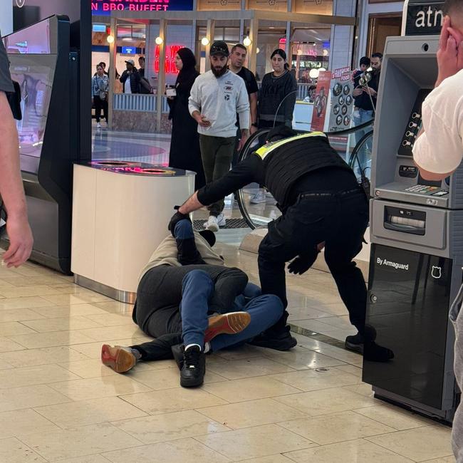 The man, who was allegedly wielding a machete, was pinned down by the shopper until police arrived. Picture: X/@alexcmhwee