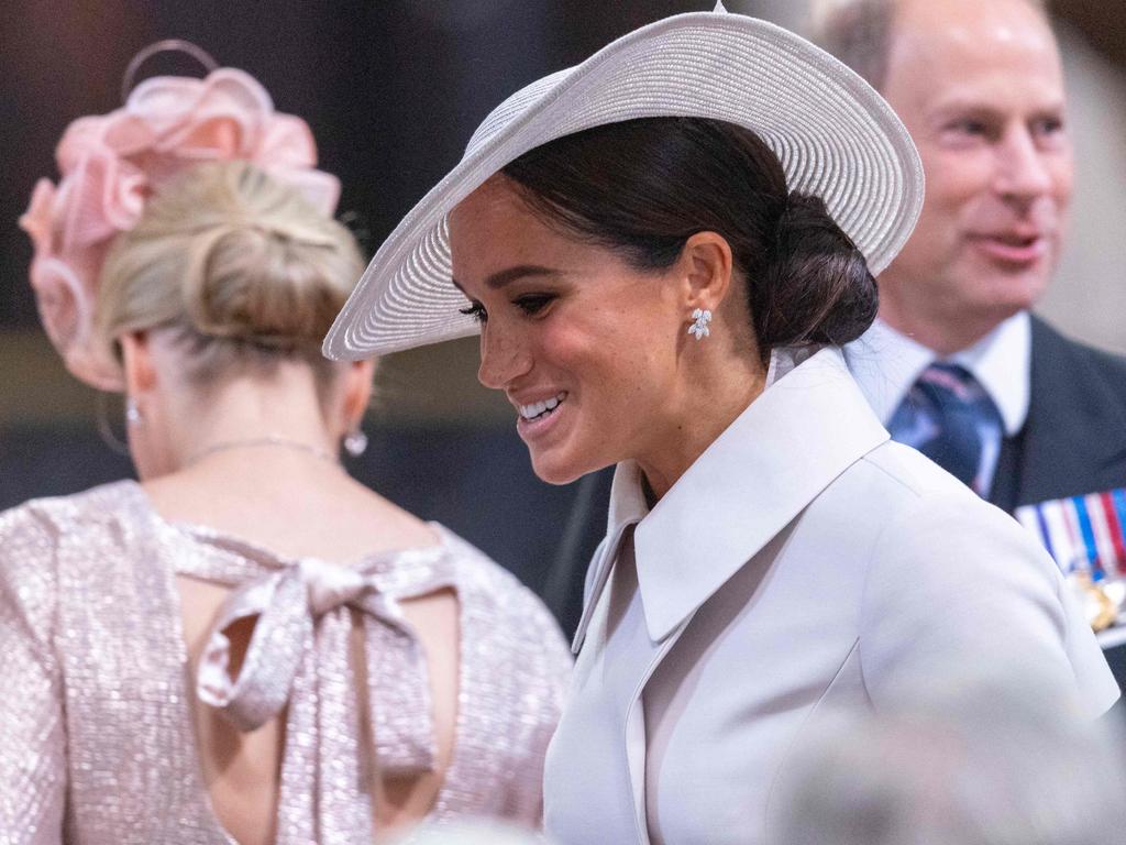 Meghan smiles as she prepares to take her seat inside the cathedral. Picture: AFP