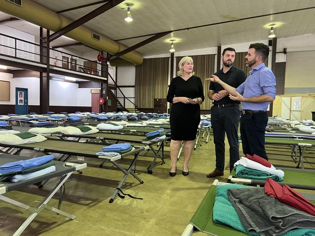 Chief Minister Eva Lawler, Emergency Services Minister Brent Potter and Deputy Chief Minister Chansey Paech tour Foskey Pavilion where hundreds of beds have been set up in case widespread evacuations are needed from flooded communities. Picture: Fia Walsh