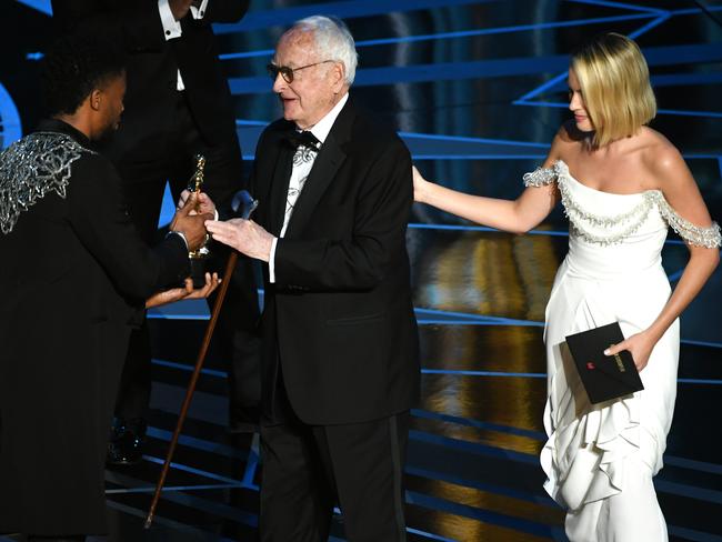 James Ivory accepts the Oscar for Best Adapted Screenplay for Call Me by Your Name from Chadwick Boseman and Margot Robbie. Picture: Getty Images