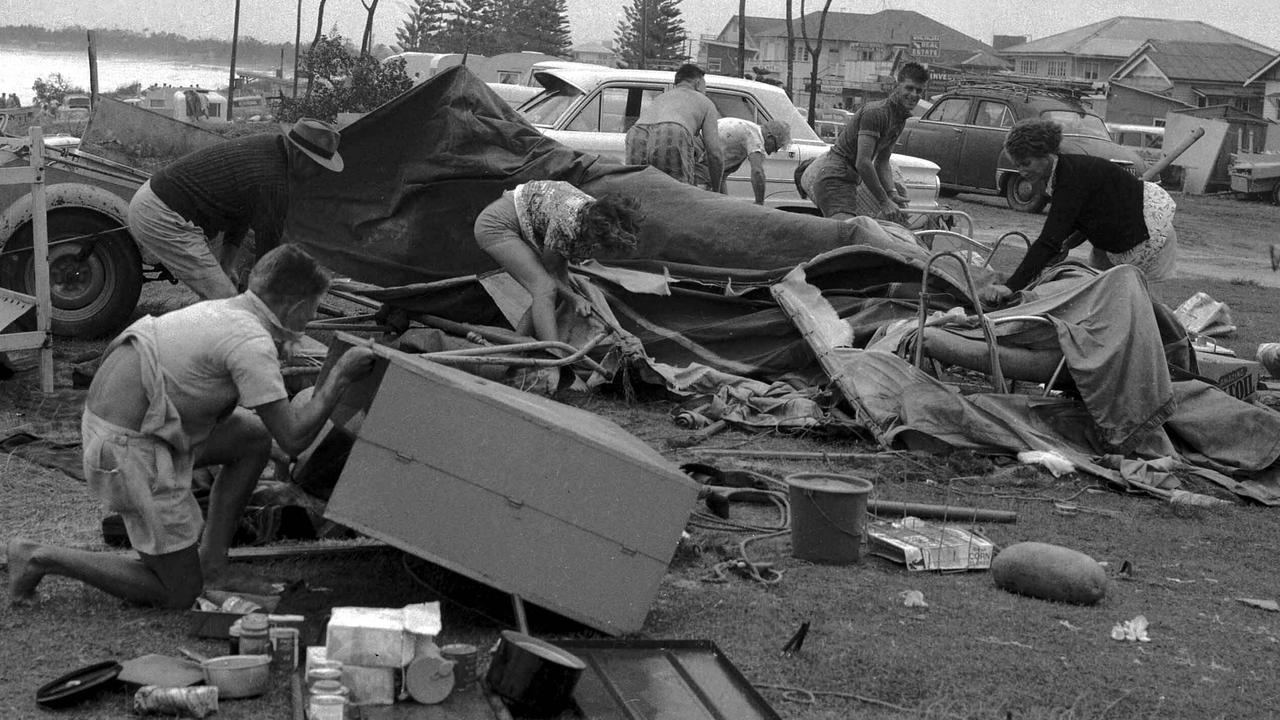 Typical of many surfside camp sites after Cyclone Annie made landfall New Year’s Day 1963. Mr V Clancy and family of Moorooka sorted through their wrecked camp at Mooloolaba Picture by Al Pascoe/The Courier-Mail Photo Archive