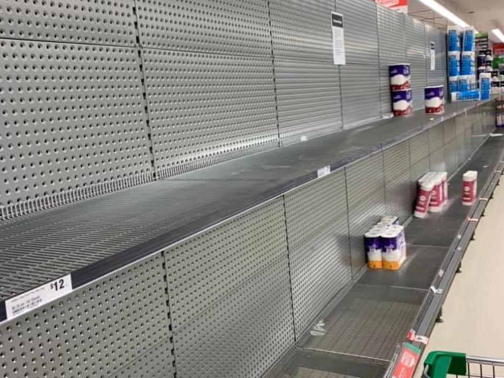 Shelves stripped of toilet paper in a Woolworths store. Picture: Facebook