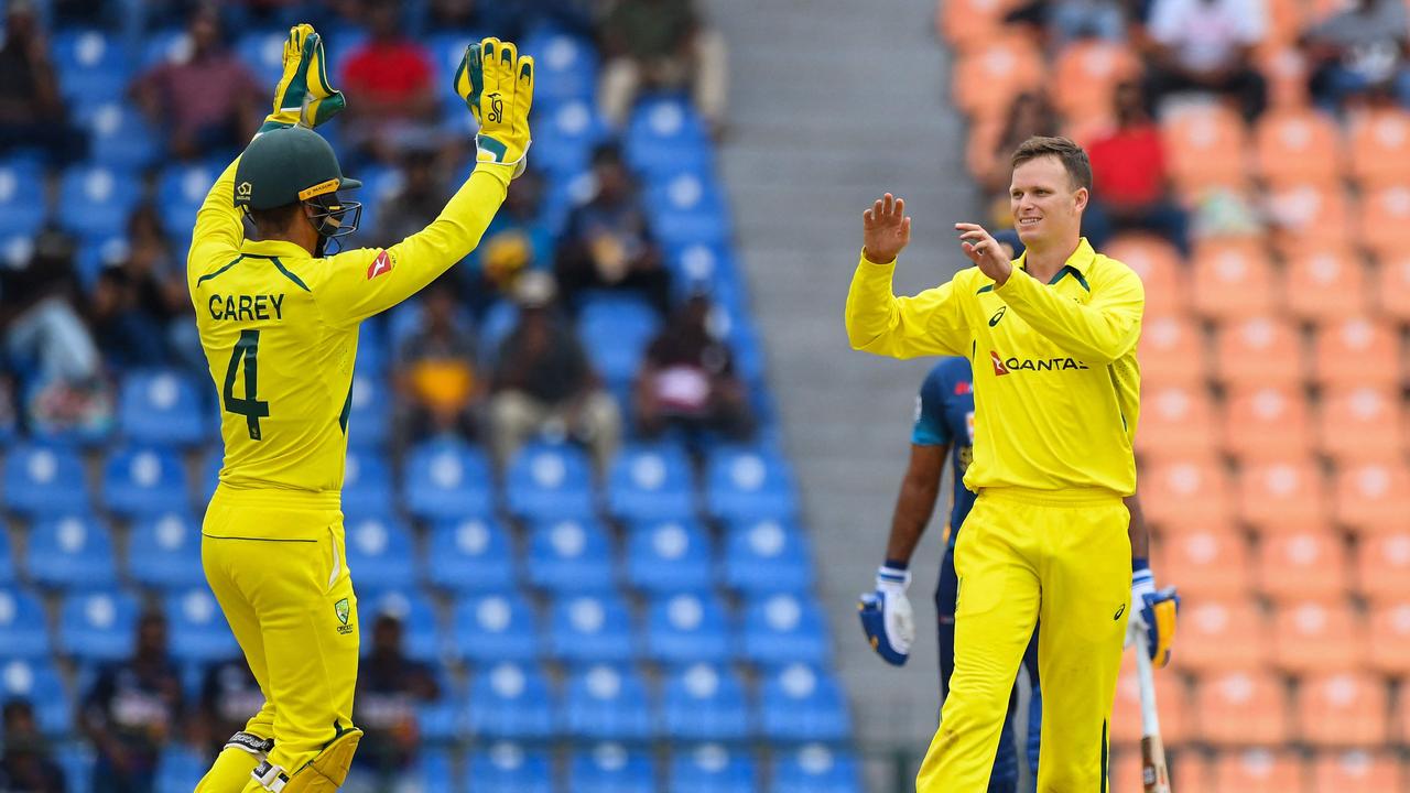 Australia's Matthew Kuhnemann (R) celebrates with teammate Alex Carey after taking the wicket of Sri Lanka's Pathum Nissanka.