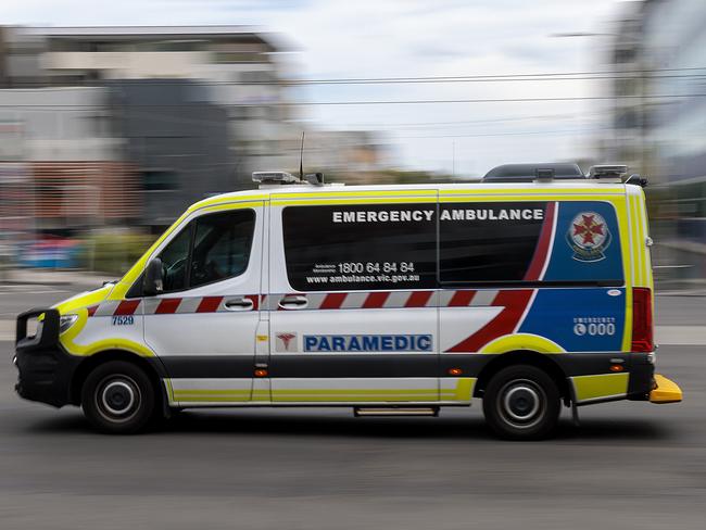 MELBOURNE, AUSTRALIA - NewsWire Photos FEBRUARY 13, 2022: An ambulance speeds away from the Royal Melbourne Hospital. Ambulance, Generic.Picture: NCA NewsWire / David Geraghty