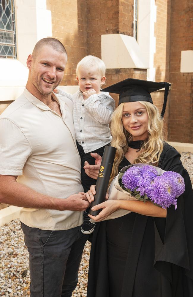 Bachelor of Paramedicine graduate Rachel Mackney with Louis Cartmill holding Oliver Cartmill at a UniSQ graduation ceremony at The Empire, Tuesday, June 25, 2024. Picture: Kevin Farmer