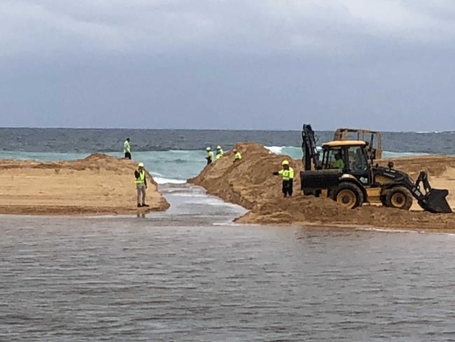 A channel through the sand links Narrabeen Lagoon with the ocean. Picture: Jim O'Rourke