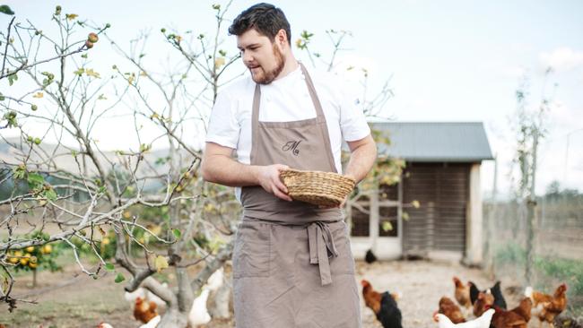 Thomas Boyd with the chooks whose eggs are integral to his signature dish. Picture: Dominique Cherry.