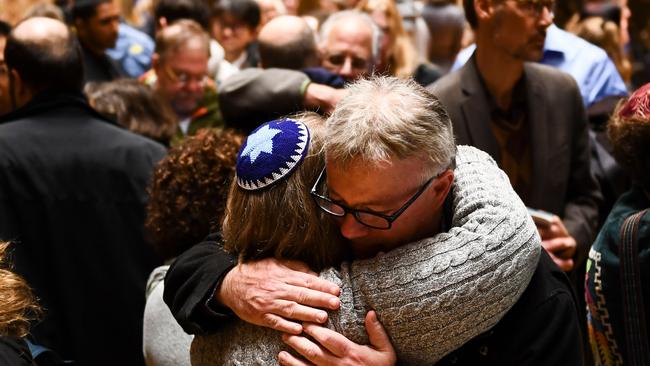 People hug after a vigil to remember the victims of the shooting at the Tree of Life synagogue. Picture; AFP.